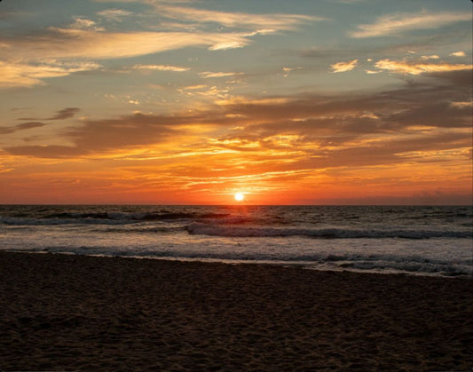 A gorgeous ocean front sunrise splashes vibrant colors across the sky. 11x14 metal print.