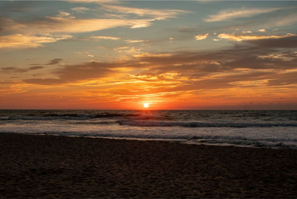 A gorgeous ocean front sunrise splashes vibrant colors across the sky. 20x30