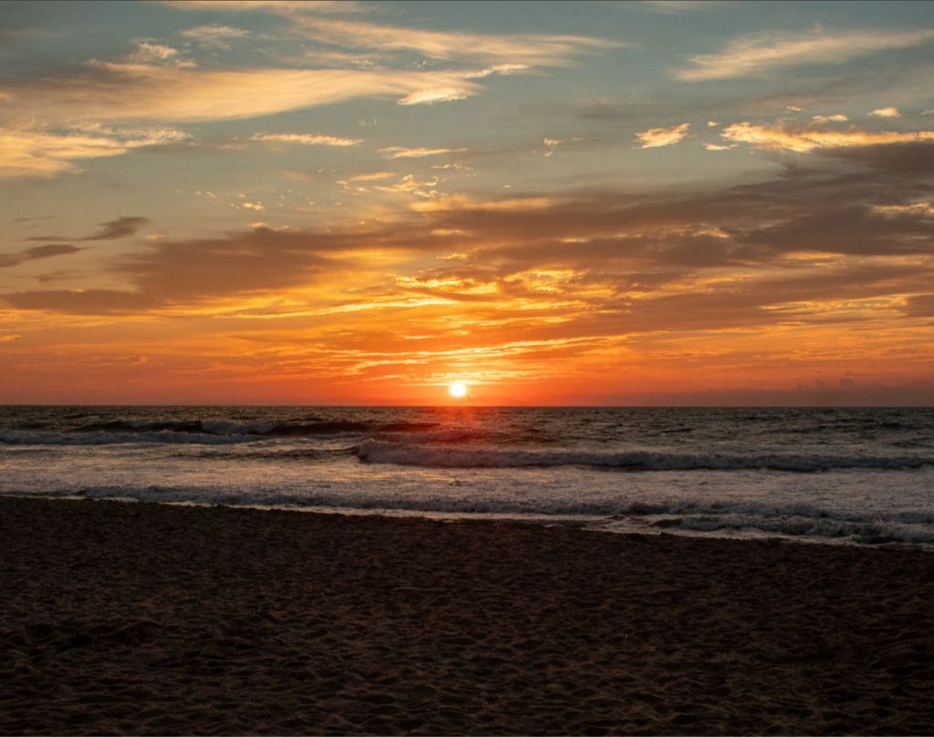 A gorgeous ocean front sunrise splashes vibrant colors across the sky. 11x14 