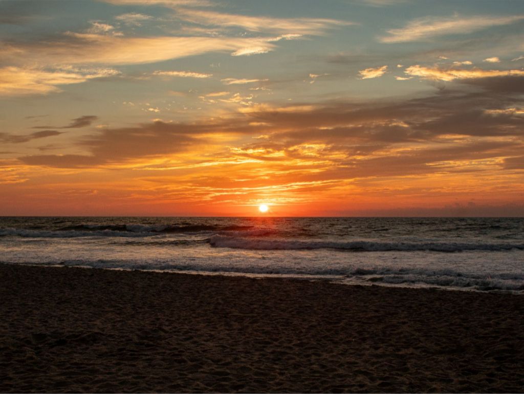 A gorgeous ocean front sunrise splashes vibrant colors across the sky. 30x40